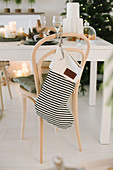 Black-and-white striped Christmas stocking on chair backrest