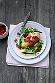 Chicken breast with snowball fruit, ham and herbs