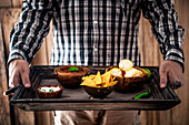 Man with snacks and dips (Mexican food)