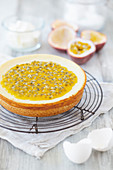 Cheesecake with passion fruit on a wire rack, and various baking ingredients
