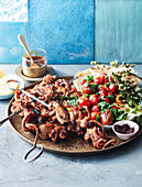 Glazed octopus skewers with chunky fattoush