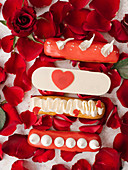 Eclairs with decorations and red rose petals