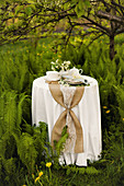 Table festively set for afternoon coffee in garden