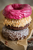 Three donuts with different glazes, stacked