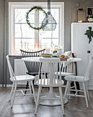 Windsor chairs painted black and white at dining room below window
