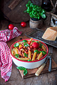 Pasta penne with pepper, tomato sauce and bacon