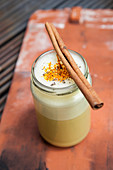 Golden Milk with turmeric and a cinnamon stick