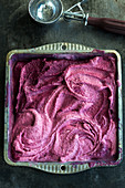 Homemade cherry yoghurt ice cream in a square tin (top view)