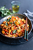 Udon noodles with crispy tofu cubes, chili and Thai basil (Asia)