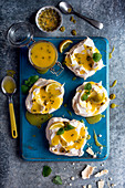 Pavlova with lemon and passion fruit curd, fresh passion fruit and mint