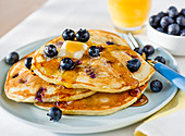 Pancakes with blueberries, butter and syrup