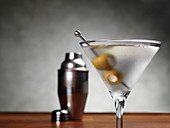 A martini cocktail with olives