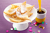 Deep-fried pastries with icing sugar for carnival