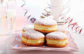 Doughnuts for carnival with streamers and a glass of champagne