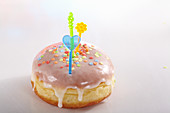 A carnival doughnut decorated with sugar confetti