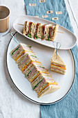Club sandwiches with beef carpaccio, and with omelette and ham