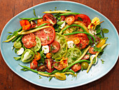 Mixed tomato salad with beans and mozzarella (top view)