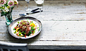 Duck breast on mango and pepper salad with watercress and spring onions