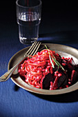 Pomegranate pasta on a pewter plate