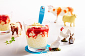 Vanilla rice pudding with strawberry sauce in small glasses