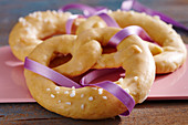 Sweet New Year's Eve pretzels with sugar nibs and a purple ribbon