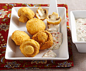 Breaded, crispy fried mushrooms with a vegetable dip made from mayonnaise and yoghurt