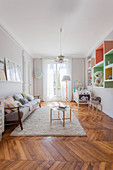 Nursery in pastel shades in period apartment with herringbone parquet floor