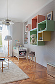 Pastel accessories in nursery with pale grey walls