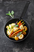 Winter vegetable stirfry with goat cheese in a pan
