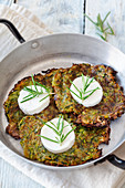 Zucchini fritters with goat's cheese in a pan