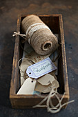 Paper and twine gift tags in wooden box