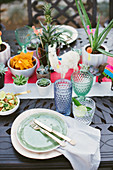 Potted succulents on table set in bright colours for Mexican party
