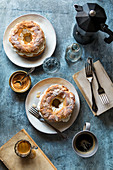 French paris-brest pastries, coffee mugs and a glass with water on the table