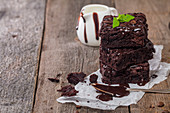 Delicious chocolate brownie with mint on wooden table