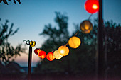 A string of lanterns as decoration for a garden party