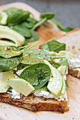 Sourdough bread with avocado, goat's cheese and baby spinach