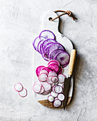 Purple beet and radish slices on a chopping board