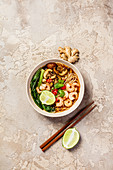 Asian soup with noodles (ramen), with miso paste, soy sauce, greens, mushrooms and shrimps prawn