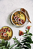 Healthy banana, trumeric, almond milk and oat breakfast bowl with fresh figs