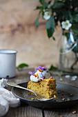 Carrot cake with cream and wild flowers