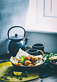 Fried green pea balls served with tea