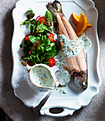 Trout with watercress sauce, salad, cherry tomatoes and oranges
