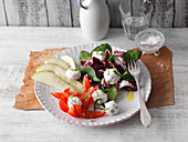A colourful salad with pears and cream cheese balls (low carb)