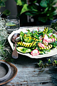 Grilled avocado with radish, cucumber and herb salad