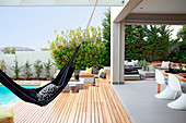 Hammock between swimming pool and roofed terrace