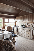 Vintage chest of drawers in open-plan kitchen-dining room in chalet