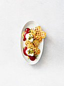 Sweet lupine waffles with raspberry sauce and cream