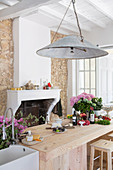 Vintage lamp above solid wood kitchen counter in front of fireplace