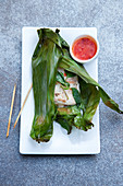 Grilled halibut with chilli oil and Thai basil wrapped in banana leaves