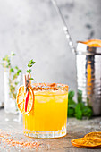 Refreshing summer citrus cocktail with orange, lemon juice and ice